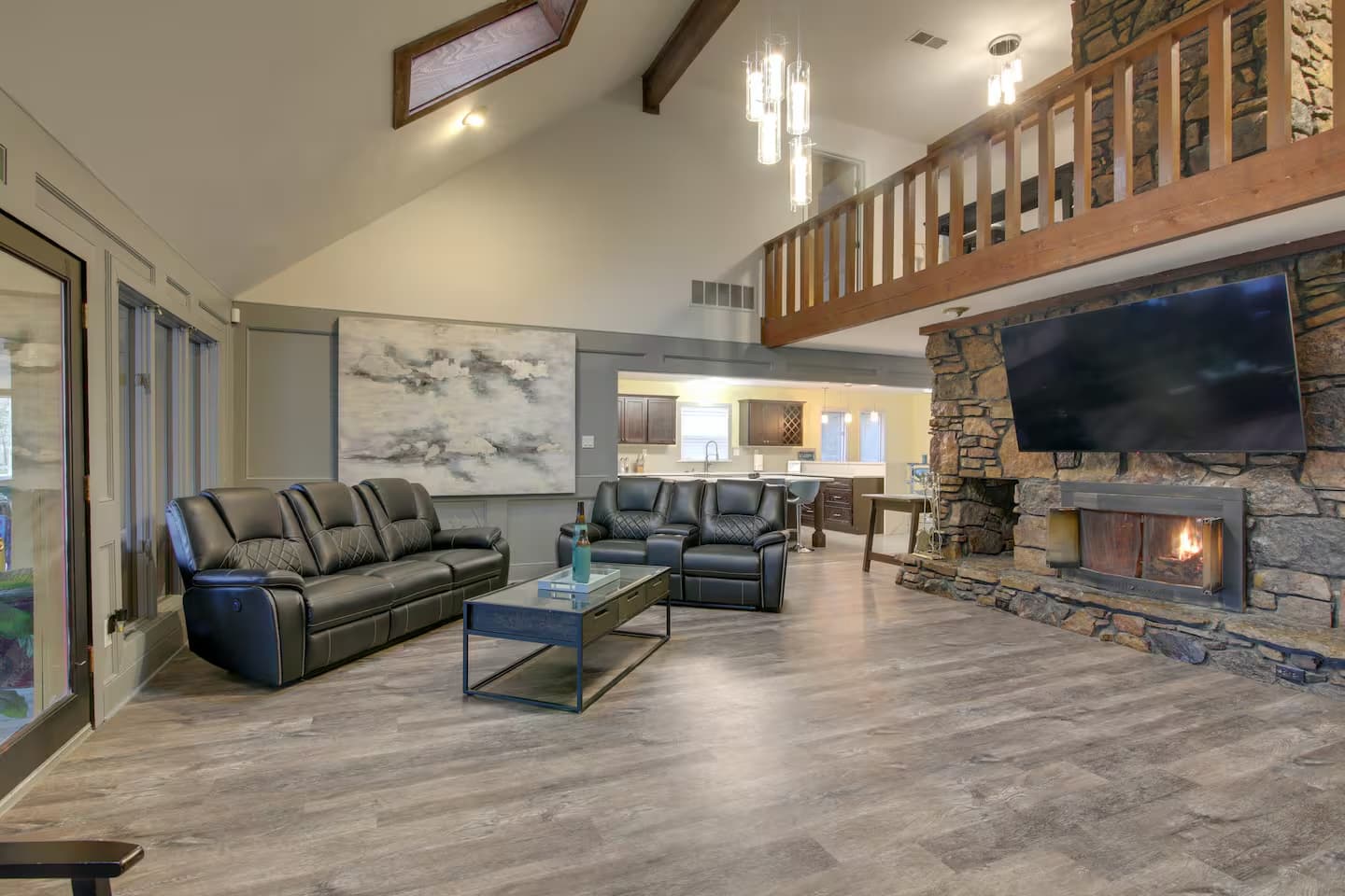 Vaulted great room with two-story stone fireplace